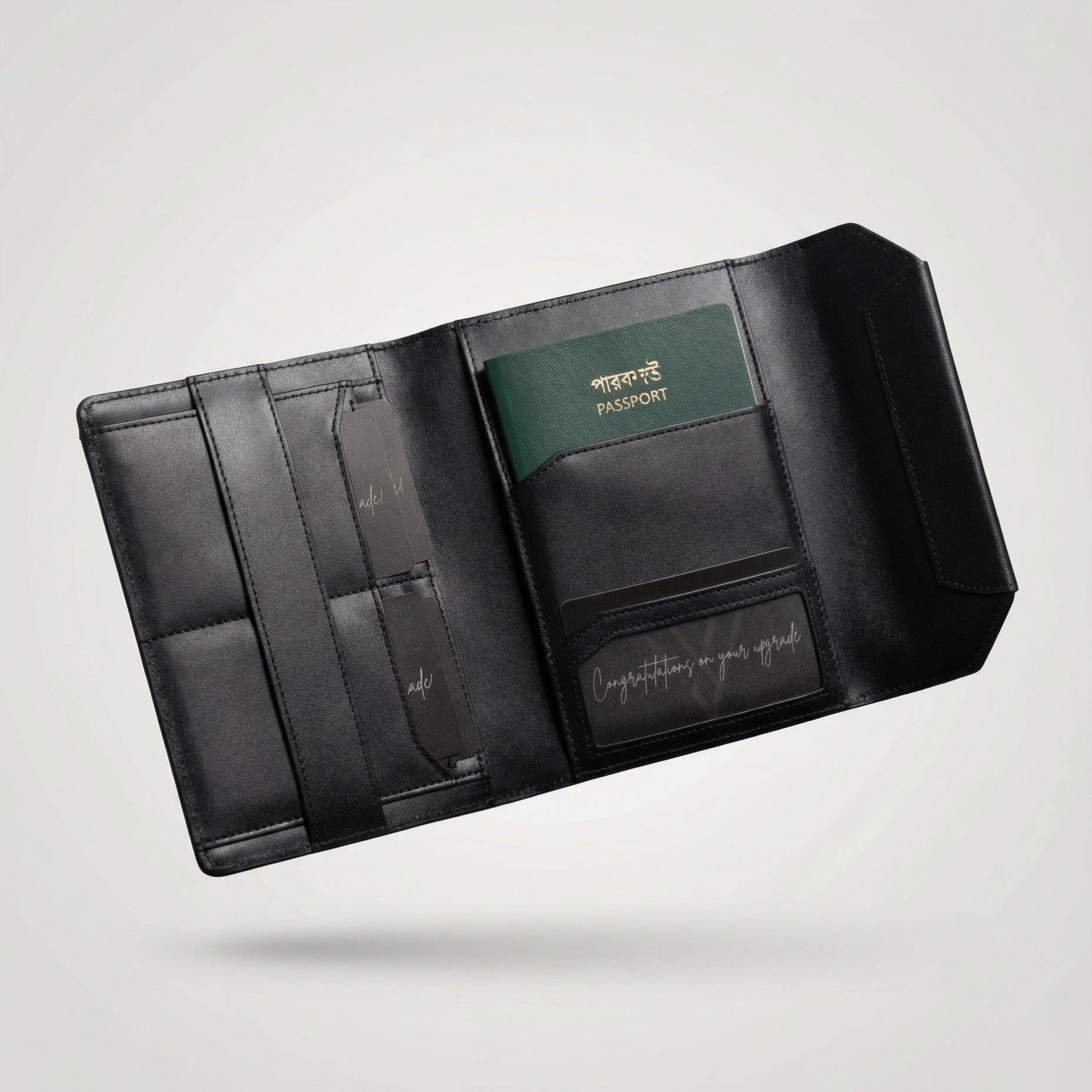 Black leather travel wallet with a passport holder on a light gray background