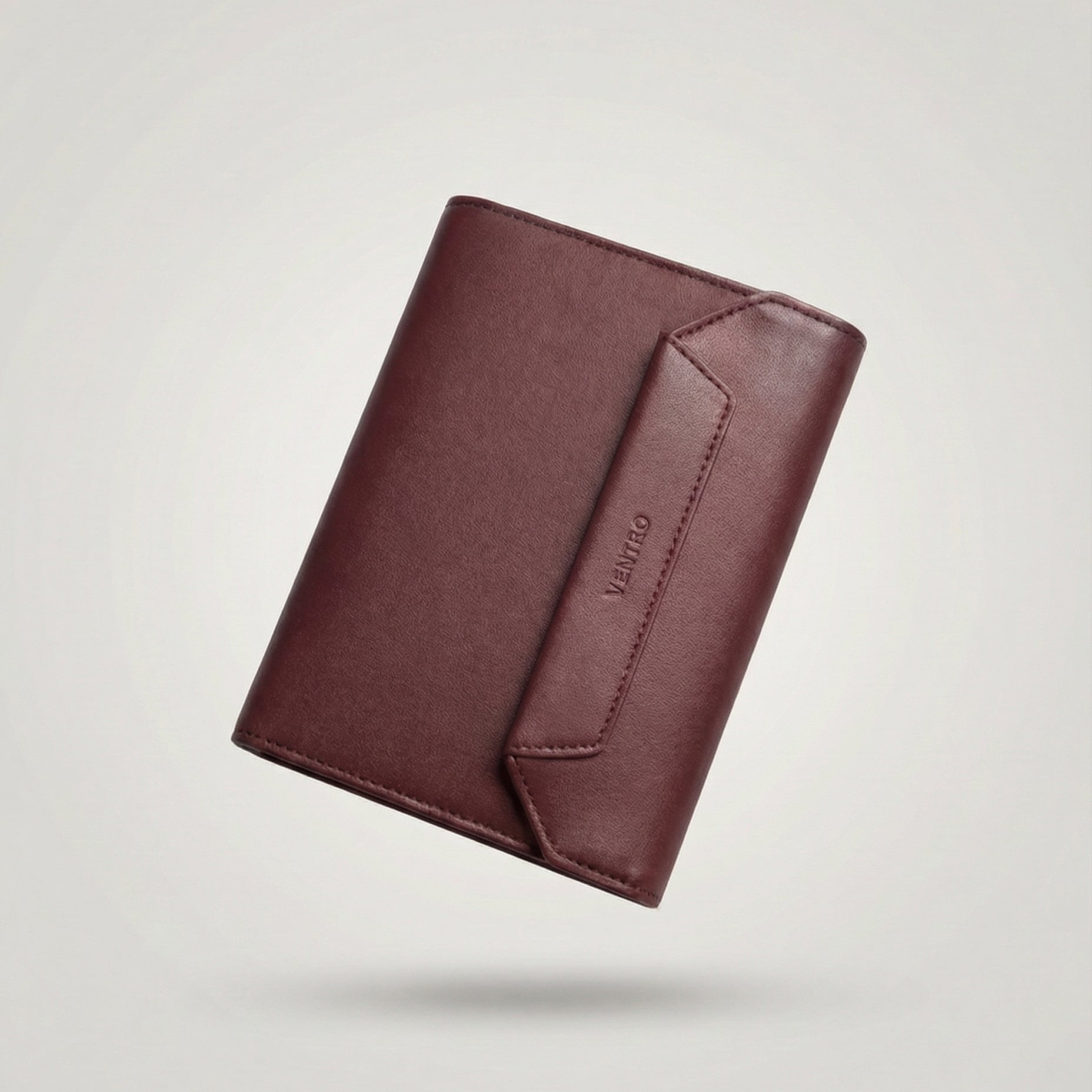 Brown leather wallet on a light gray background